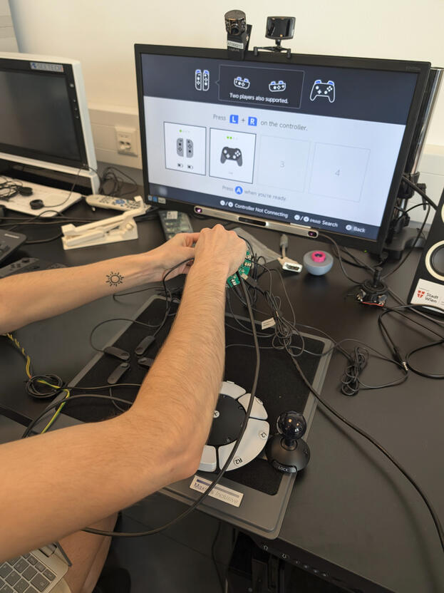 Designer testing connection for HID re-mapper with Nintendo Switch.